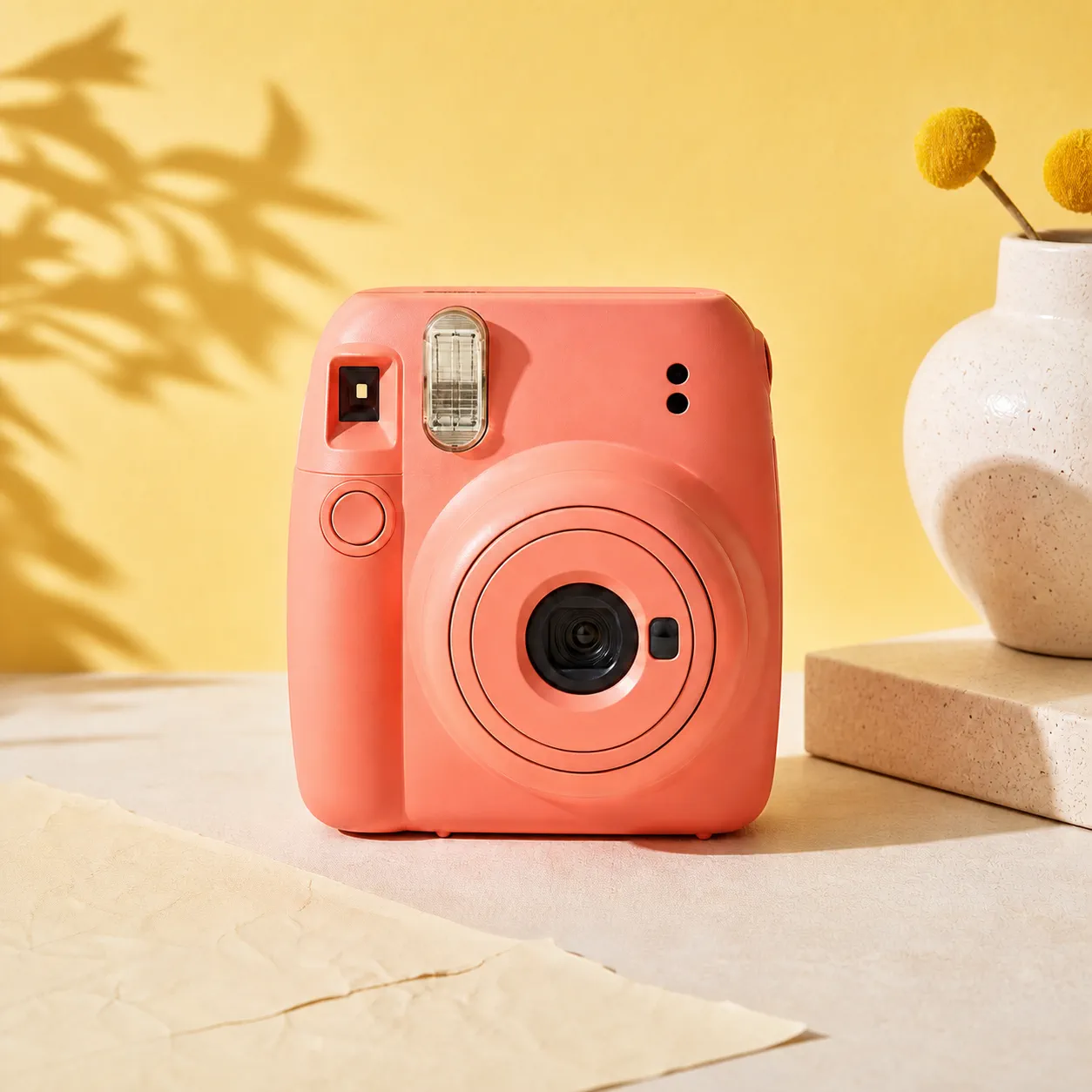 Coral instant camera on a sunny yellow set before stickers are added