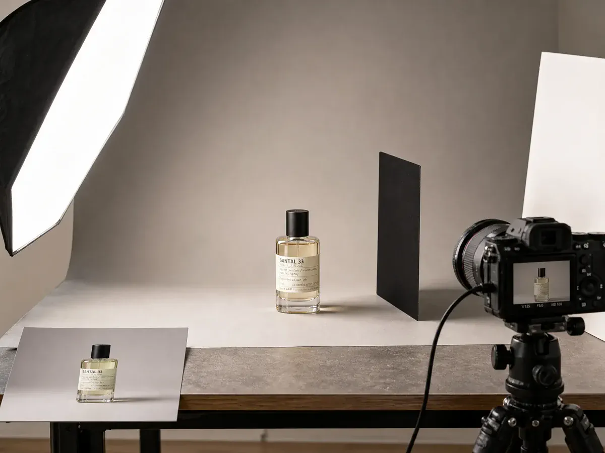 A perfume bottle inside a complete tabletop product photography setup.