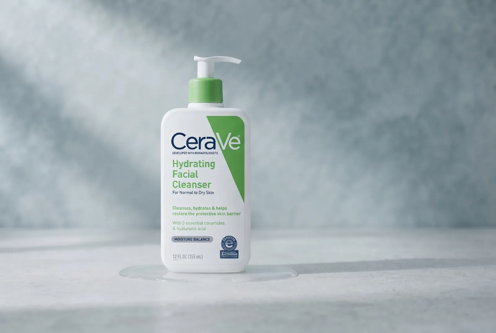 A white pump cleanser in a cool, clean skincare setting with controlled plastic highlights.
